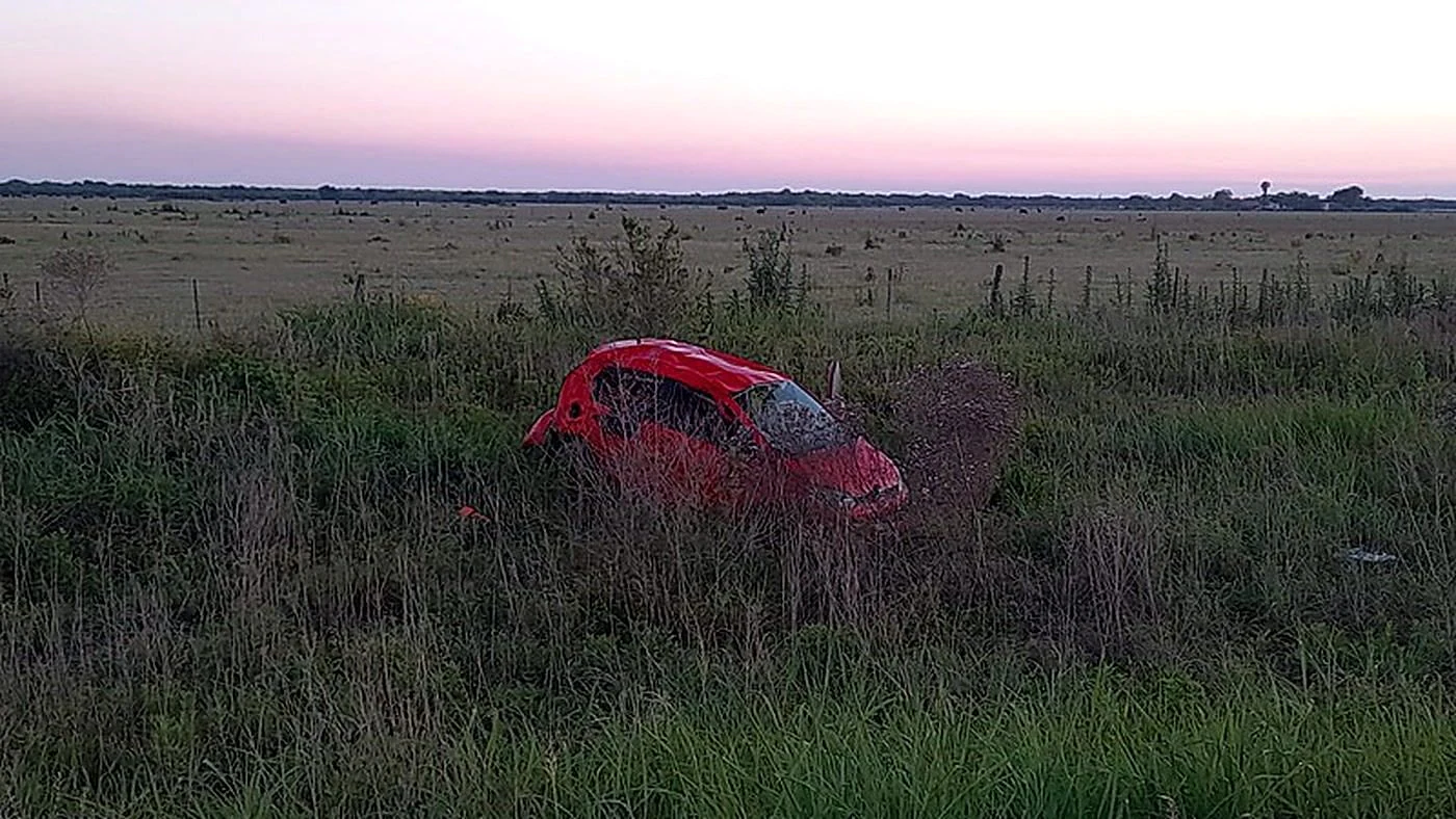Automóvil rojo en la banquina con pastizales de la Ruta Provincial 61S, cerca de Soledad, tras el siniestro fatal